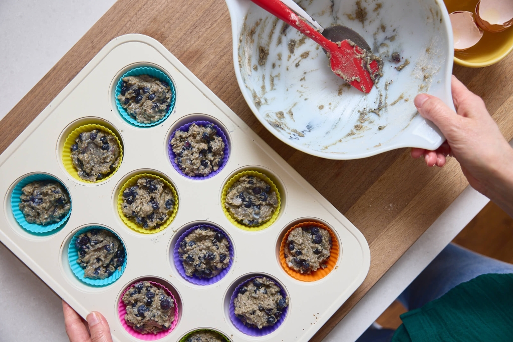Blueberry Hemp Muffins (Nut-Free & Gluten-Free!) 3 Blueberry Muffins in muffin tin ready for the oven